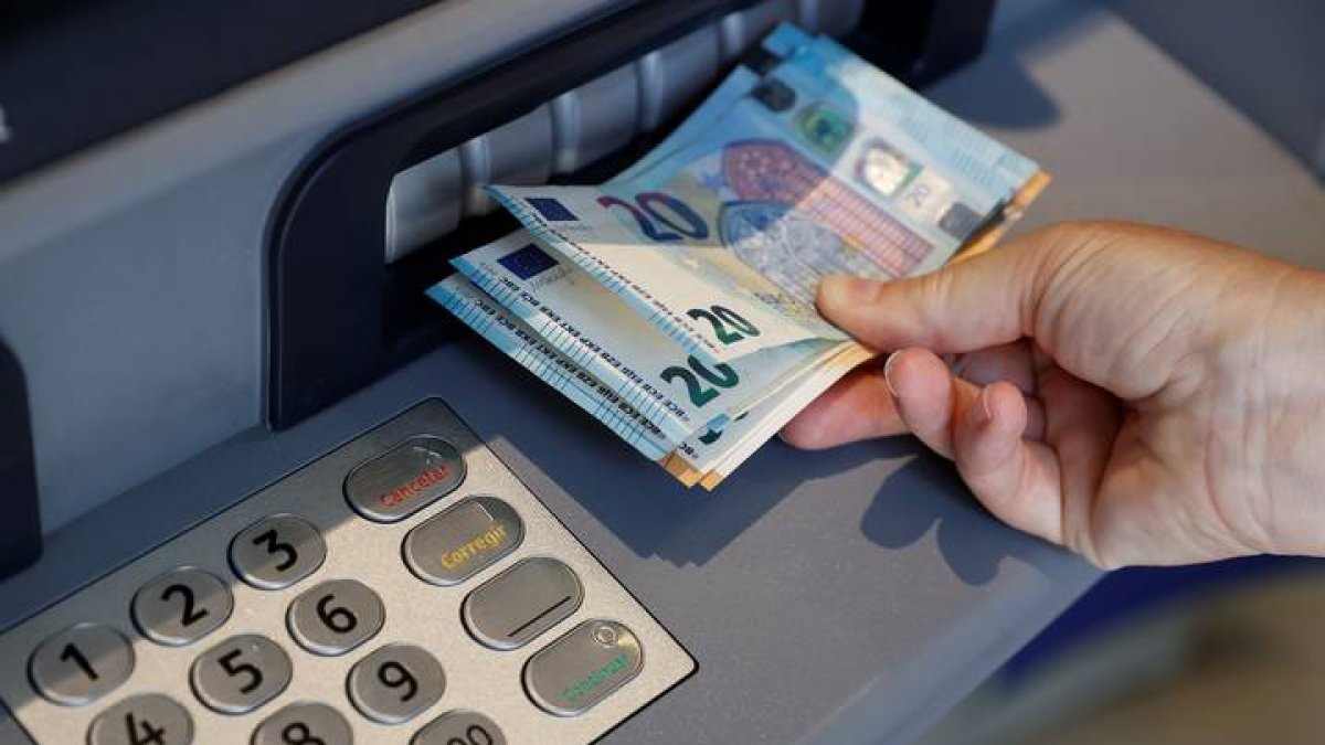 Una persona saca dinero de un cajero de una entidad bancaria. EMILIO NARANJO