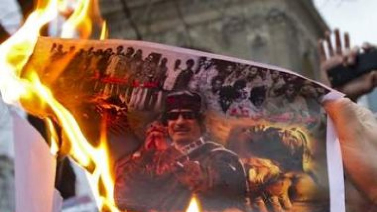 Manifestantes queman una imagen de Muamar el Gadafi durante una protesta en París.