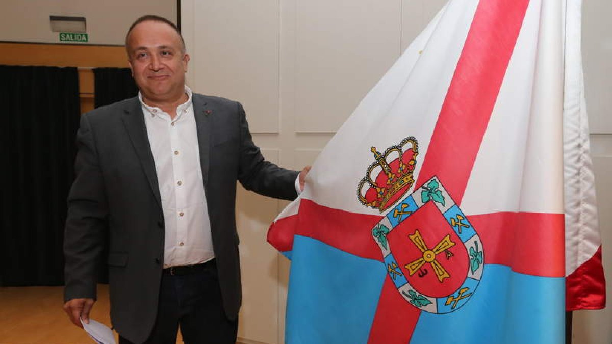 Gerardo Álvarez Courel, con la bandera oficial de la comarca del Bierzo, este verano.