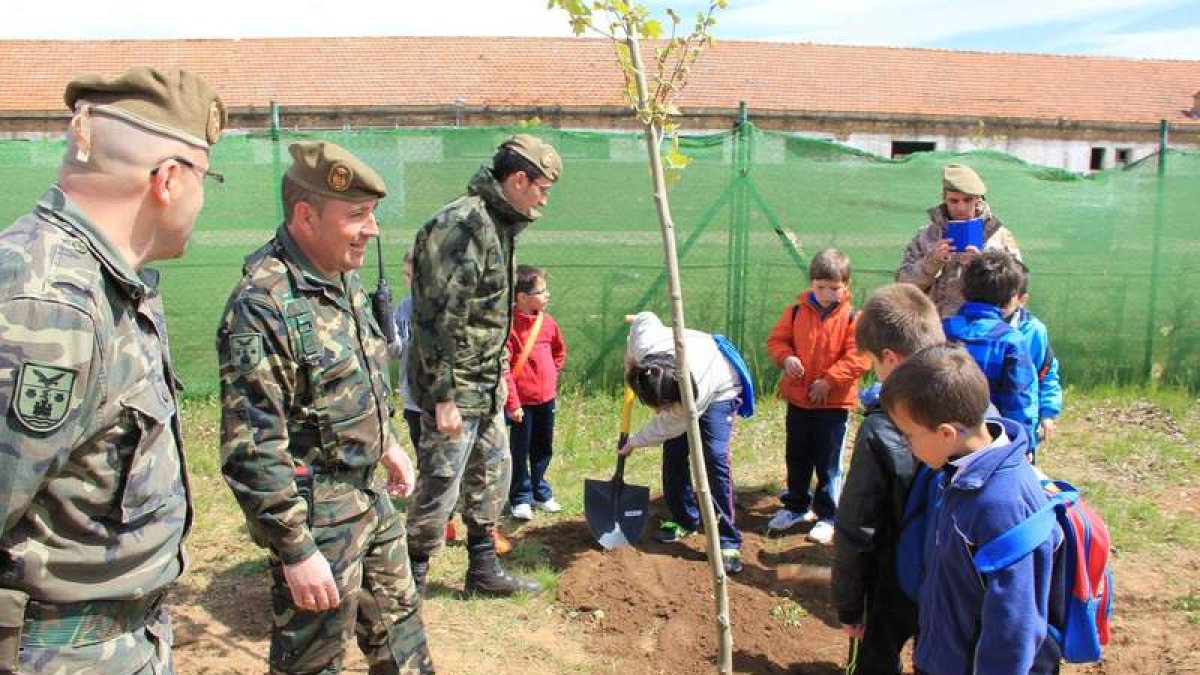 Los alumnos plantan árboles durante su visita al Acuartelamiento Santocildes de Astorga.