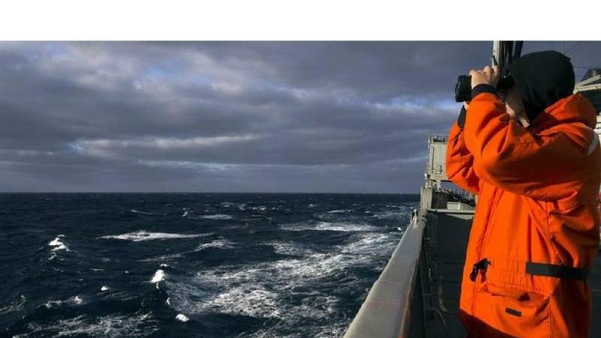 Un marine australiano otea el horizonte en el océano Índico en busca de algún rastro del avión desaparecido de Malaysia Airlines.