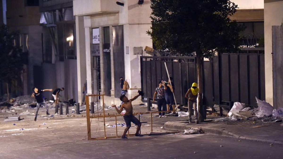 Unos manifestantes lanzan piedras al interior del Parlamento libanés. WAEL HAMZEH