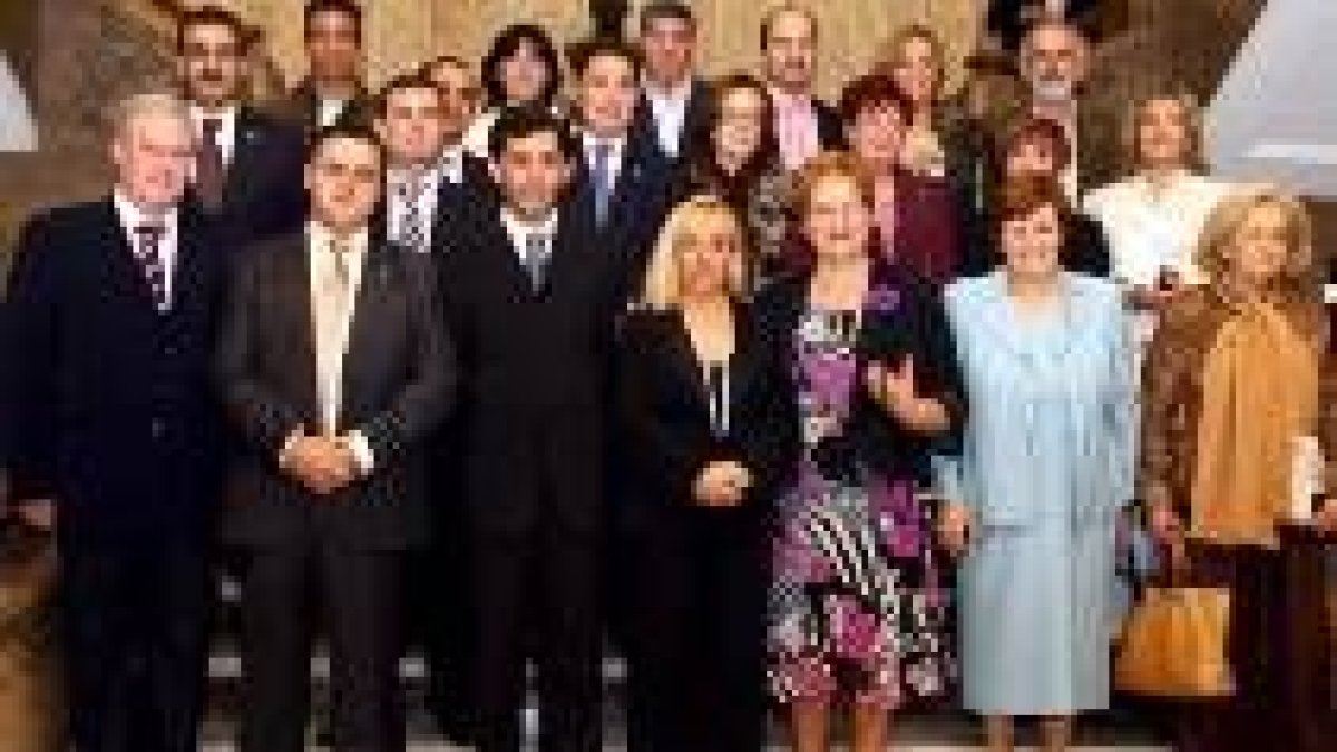 Isabel Carrasco y los diputados posan para la foto de familia con los jubilados