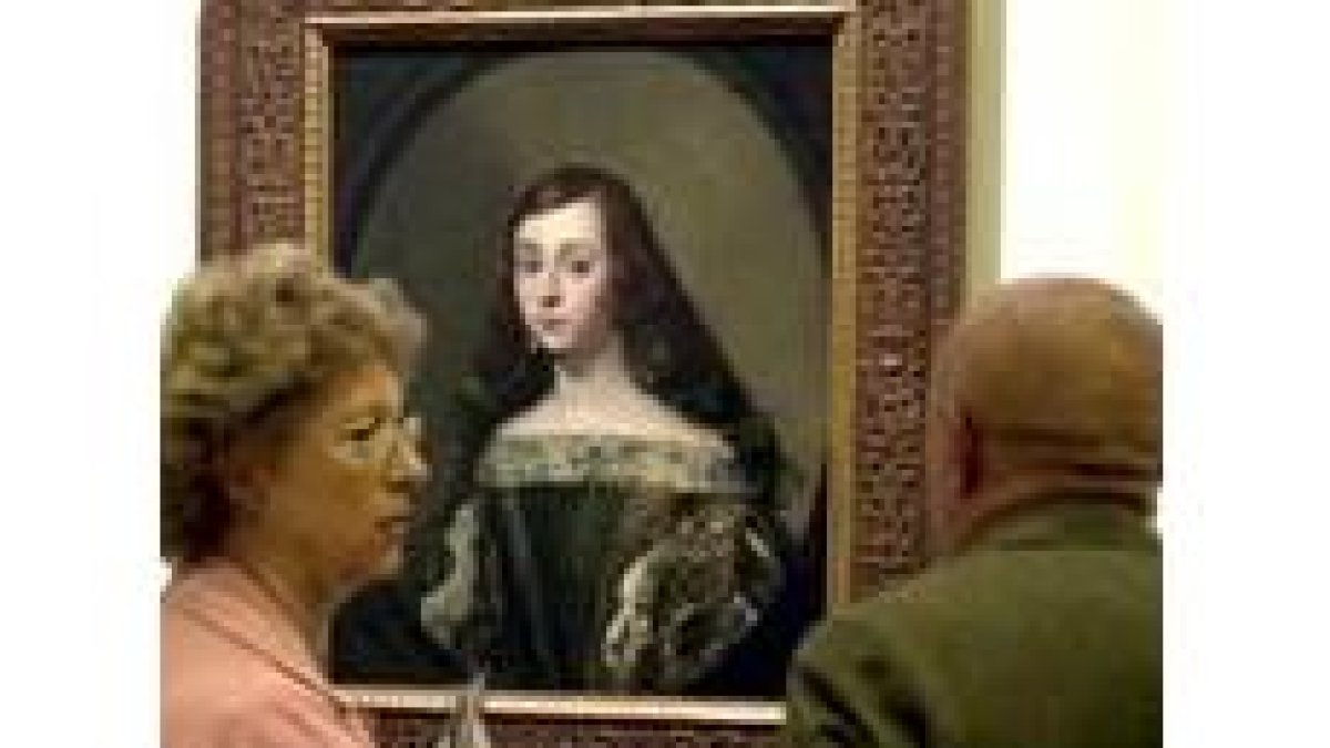 Una pareja observa el «Retrato de muchacha», de Claudio Coello
