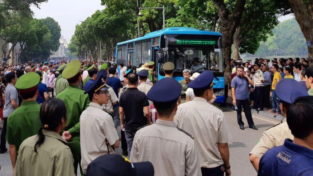 Policías rodean a manifestantes durante una protesta en las calles de Hanoi (Vietnam).