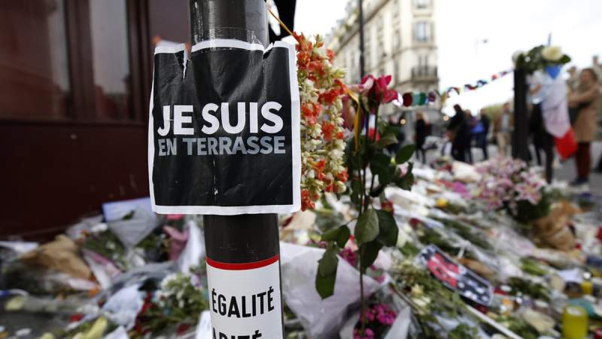 Un pequeño altar con un cartel que dice «Me quedo en la terraza» en las calles de París.