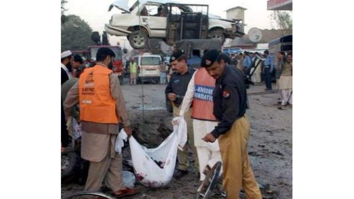 Oficiales recogen restos mortales del terrorista suicida.