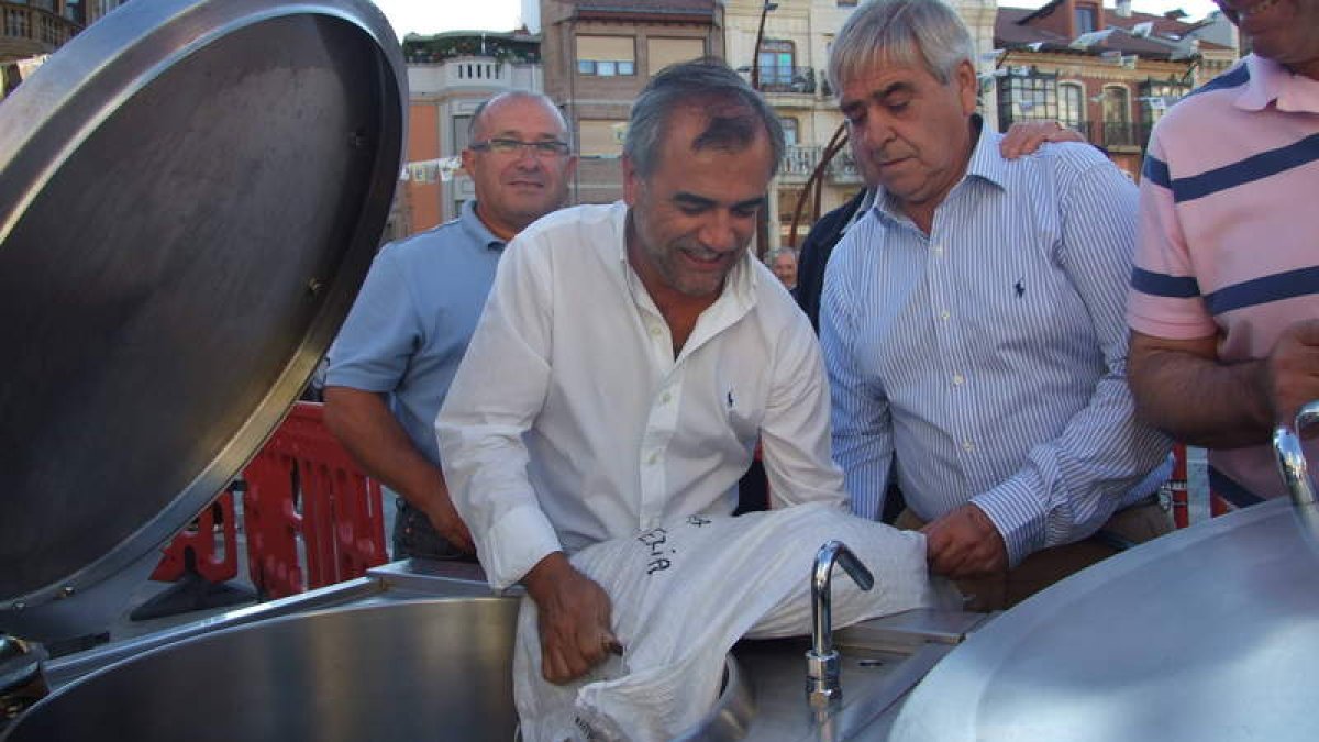 Palazuelo, flaqueado por Gallego y Rubio, vacía un saco de alubias.