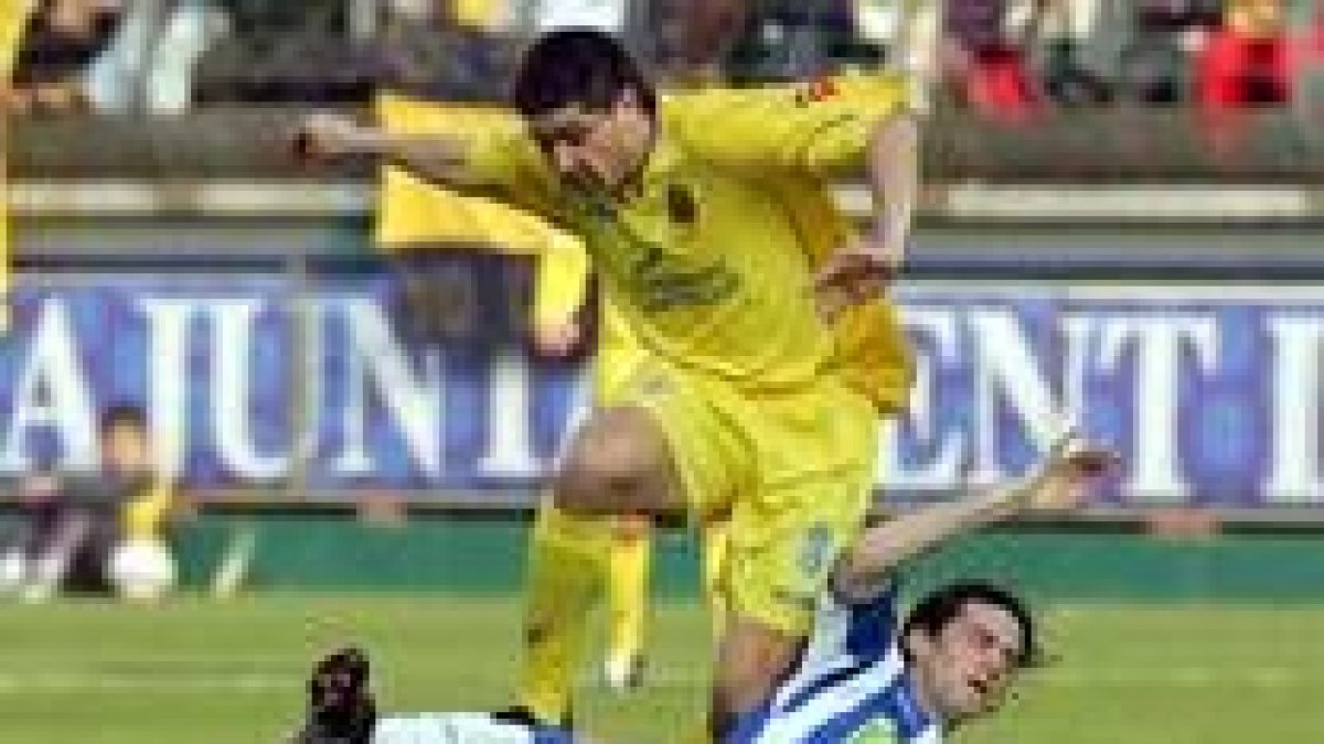 Riquelme salta sobre Daniel Jarque para superar la fuerte entrada el jugador espanyolista