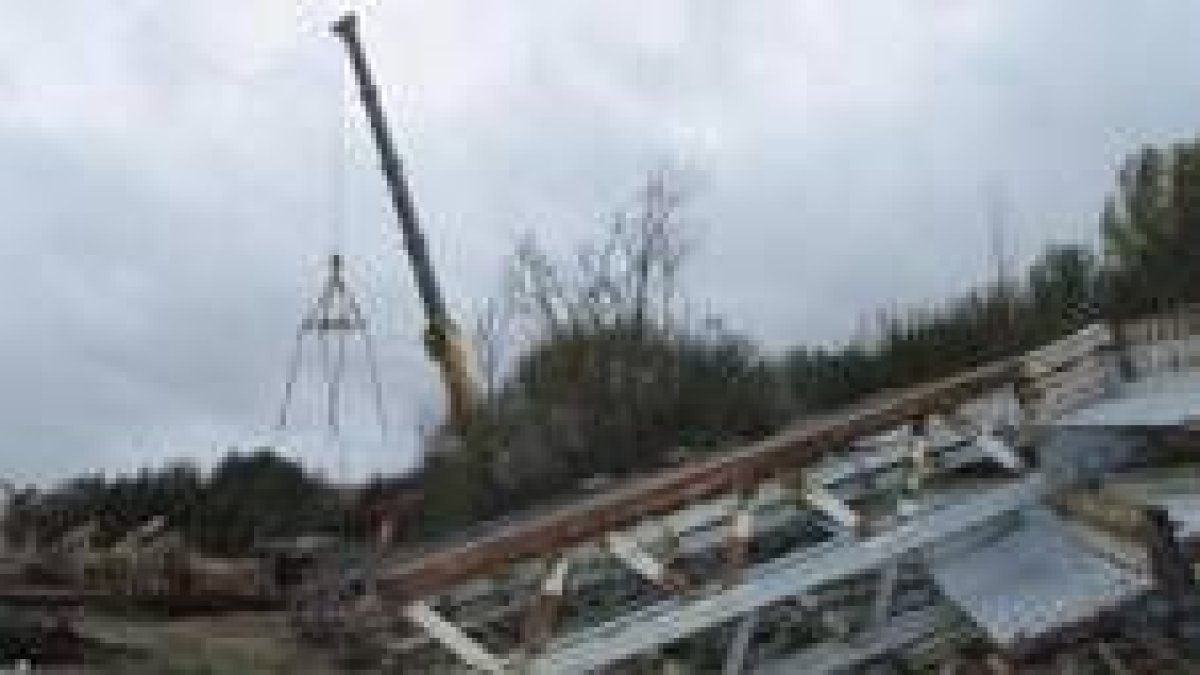 Las piezas del arco cortado y la pluma que ayer sujetaba el tablero del puente de Sopeña