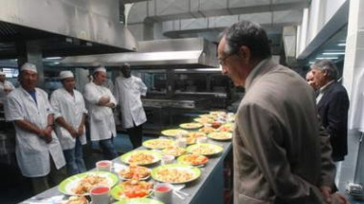 Antonio Puig y el subdelegado observan los platos realizados por los internos.