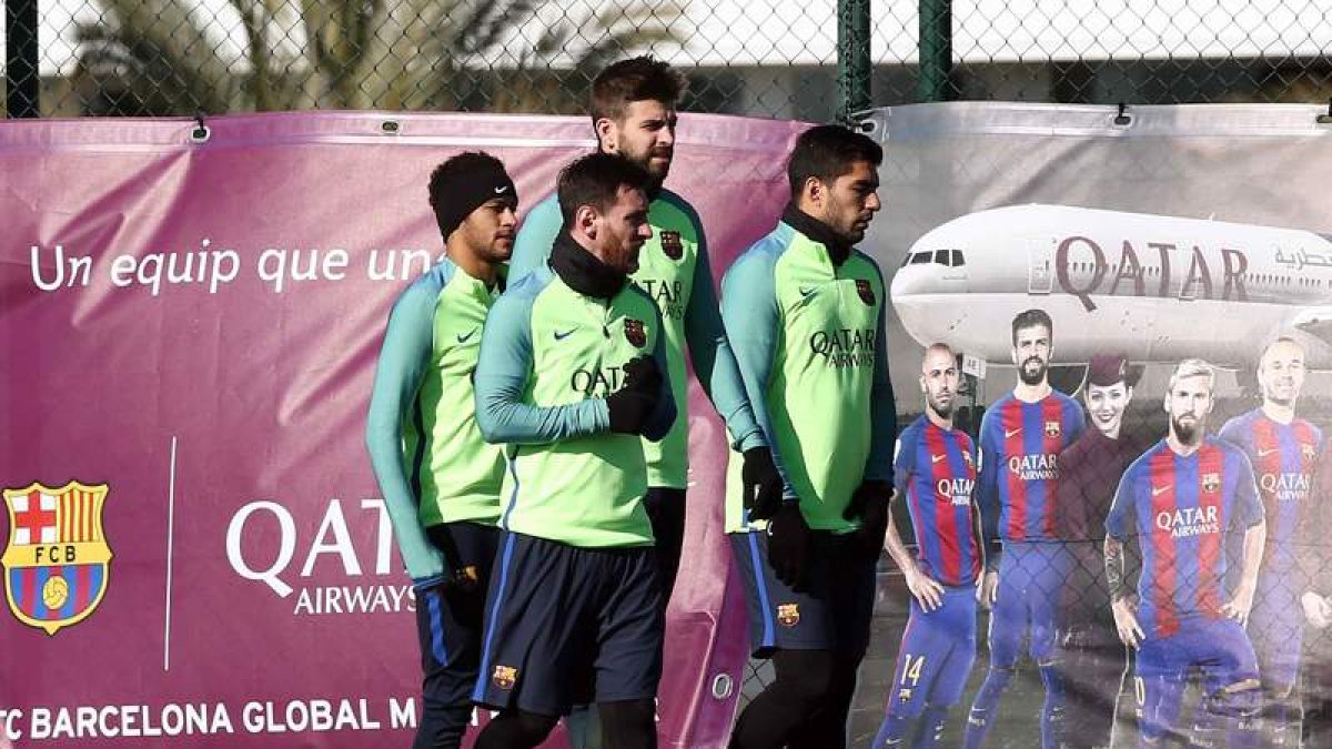 Piqué junto con el mortal tridente culé: Messi, Neymar y Suárez en el entrenamiento. TONI ALBIR