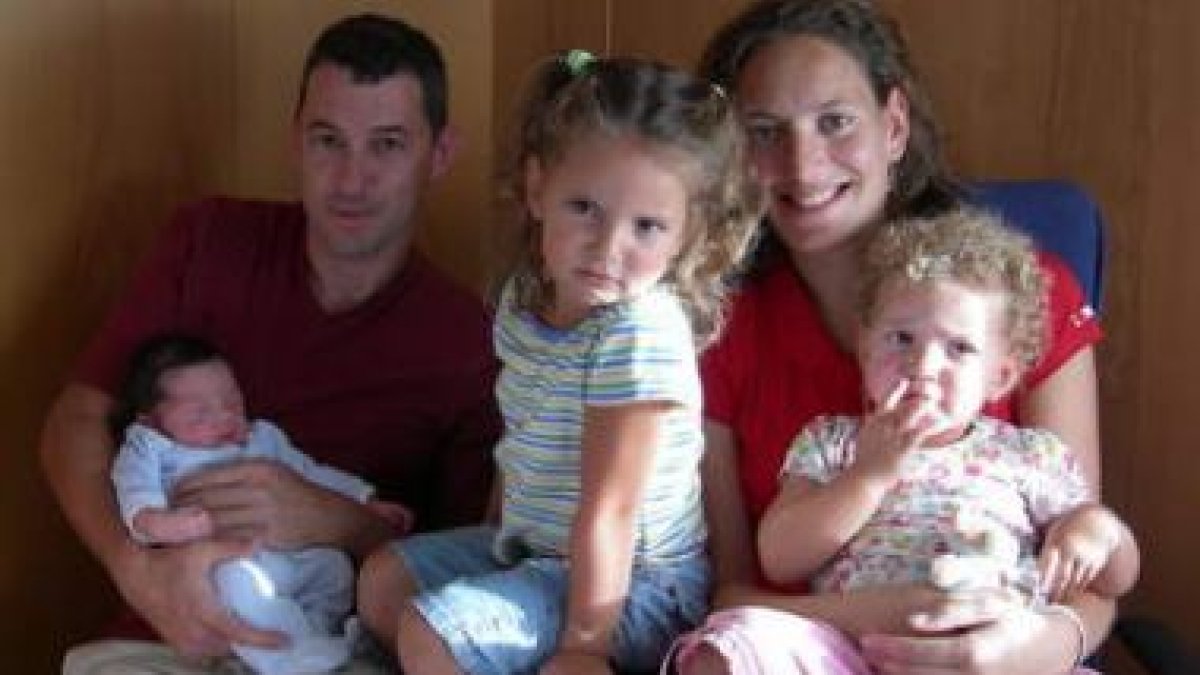 El pequeño Joaquín, en los brazos de su padre y junto a su madre y hermanas.