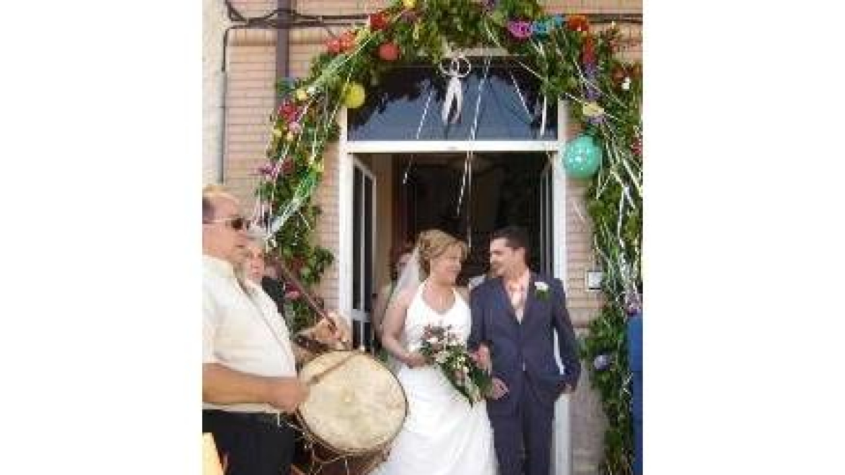 La novia sale de casa del brazo del padrino