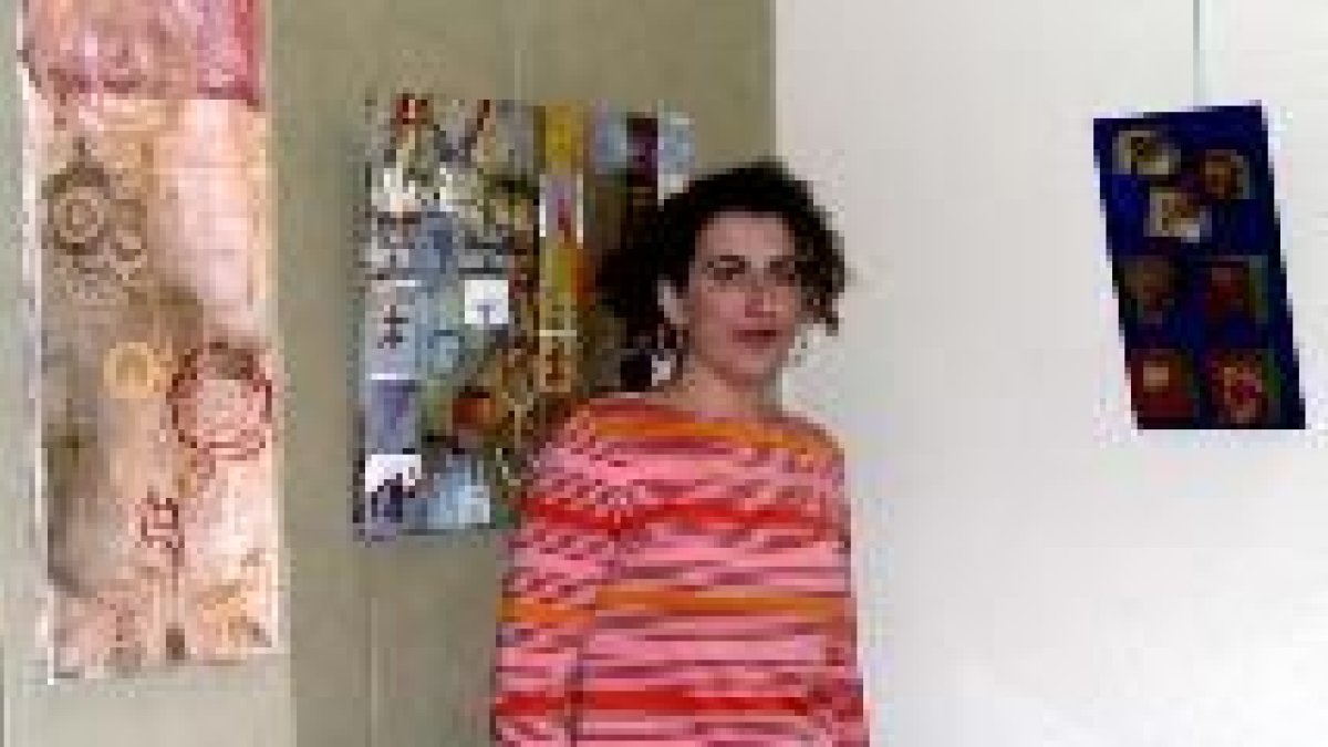 Cristina Ibáñez junto a dos de los cuadros que pueden contemplarse en Centro Arte