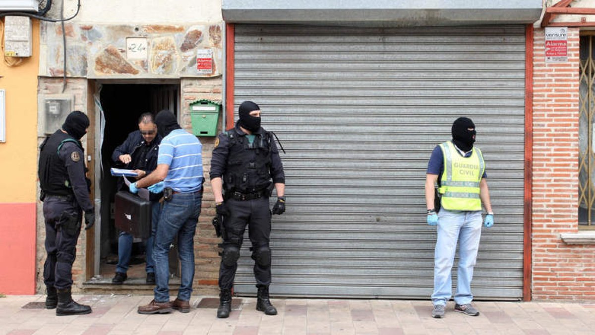 Varios guardias civiles, a las puertas de una de las viviendas registradas ayer en Valladolid.