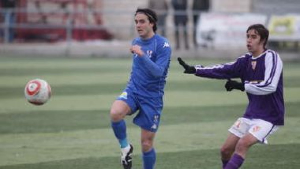 Villafañe, a la izquierda, se lleva el esférico a pesar de la oposición de un adversario.