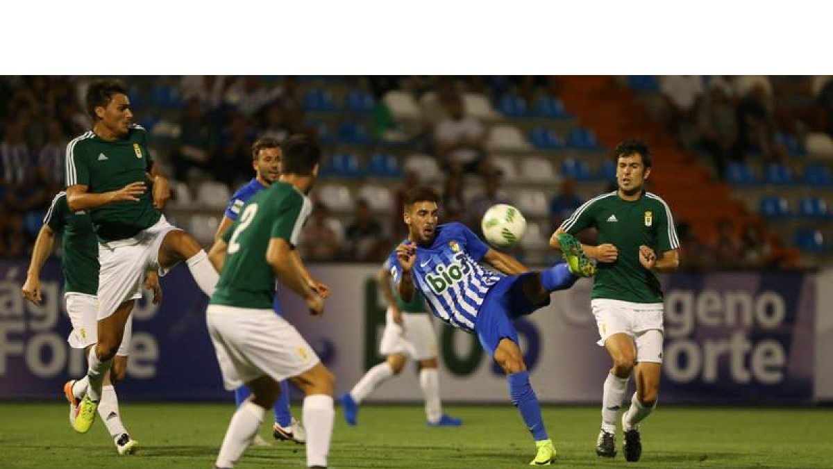 El delantero blanquiazul Héctor Figueroa remata en posición acrobática en un momento del partido disputado ayer ante el Real Oviedo en El Toralín. L. DE LA MATA