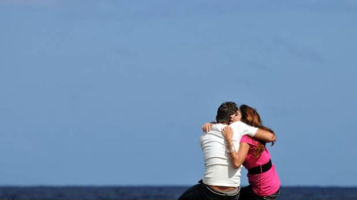 Una pareja se abraza en el malecón de La Habana.