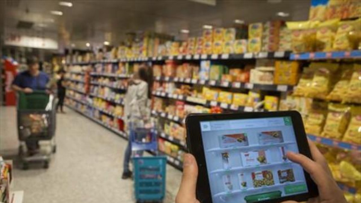 Un usuario consulta la 'app' de El Corte Inglés en uno de sus centros.