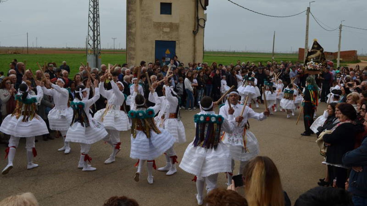Arriba y a la izquierda el grupo de danzas de Pobladura; a la derecha el de Las Lindes de Suances, durante la procesión de ayer. MEDINA