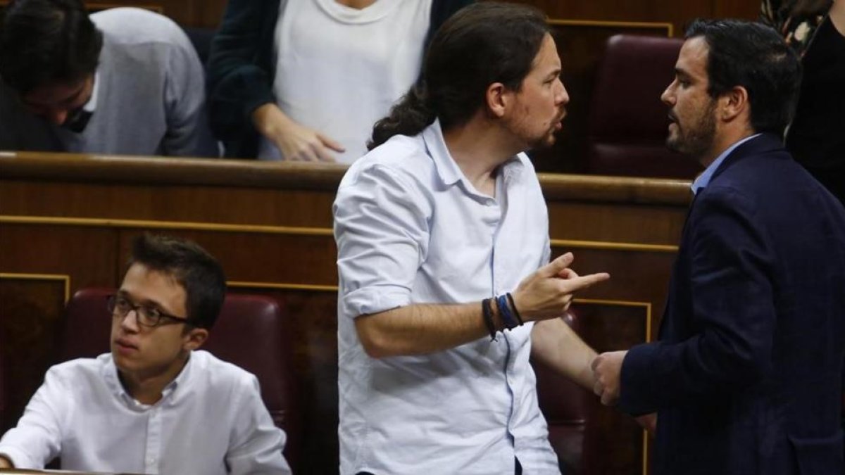Iglesias conversa con Garzón, al lado de Errejón, en el debate de investidura de Rajoy.