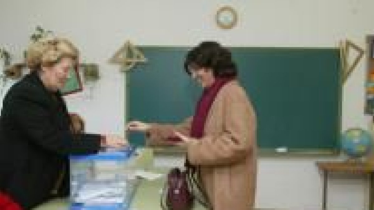 Una mujer vota por la mañana en la mesa electoral ubicada en el colegio Quevedo, en León