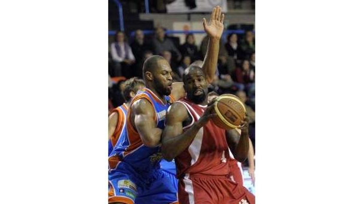 Ryan Humphrey protege el balón ante la férrea defensa del pívot del Autocid, Anagonye
