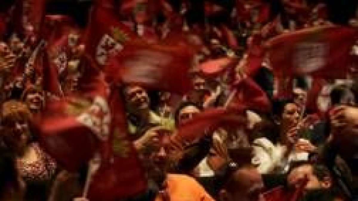 El reparto de banderas a la puerta llenó de color el Auditorio