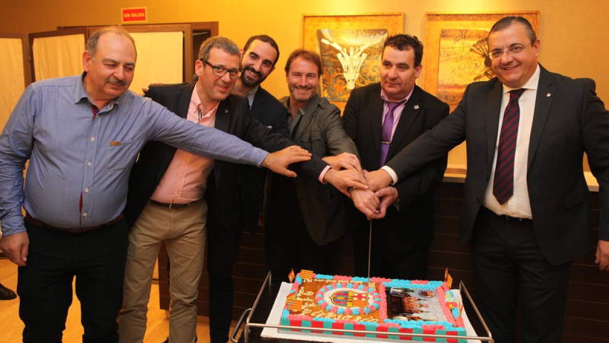 La tarta aniversario (arriba), Juan Carlos entregando un presente y la foto firmada por el ‘tridente’.