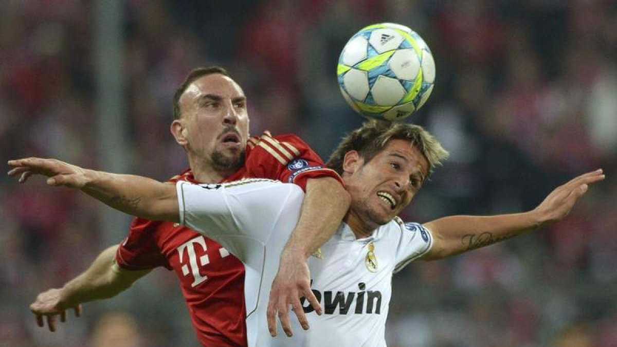 El futbolista francés Frank Ribéry, del Bayern de Múnich, lucha por el balón con el defensa portugués del Real Madrid Fabio Coentrao durante un lance del juego.