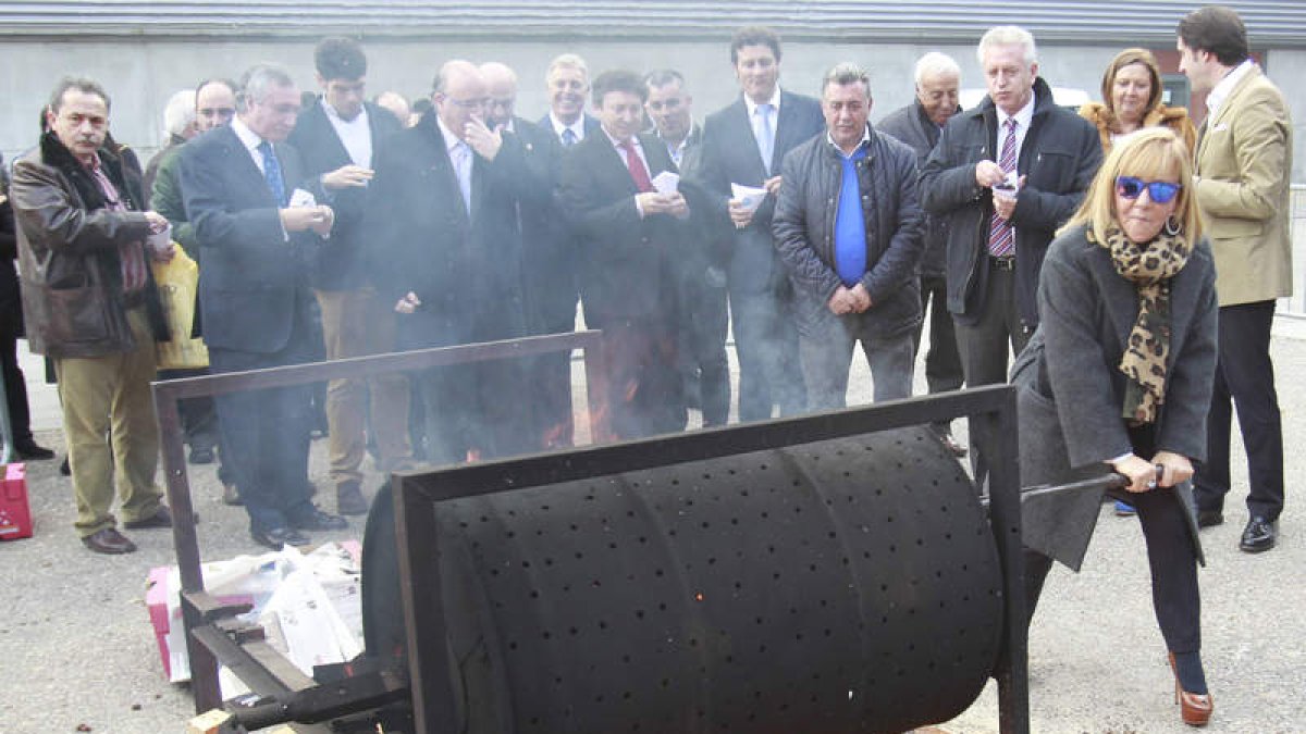 La presidenta de la Diputación de León, Isabel Carrasco, da vueltas al tambor de castañas asadas en el magosto preparado en el ferial de Intur.