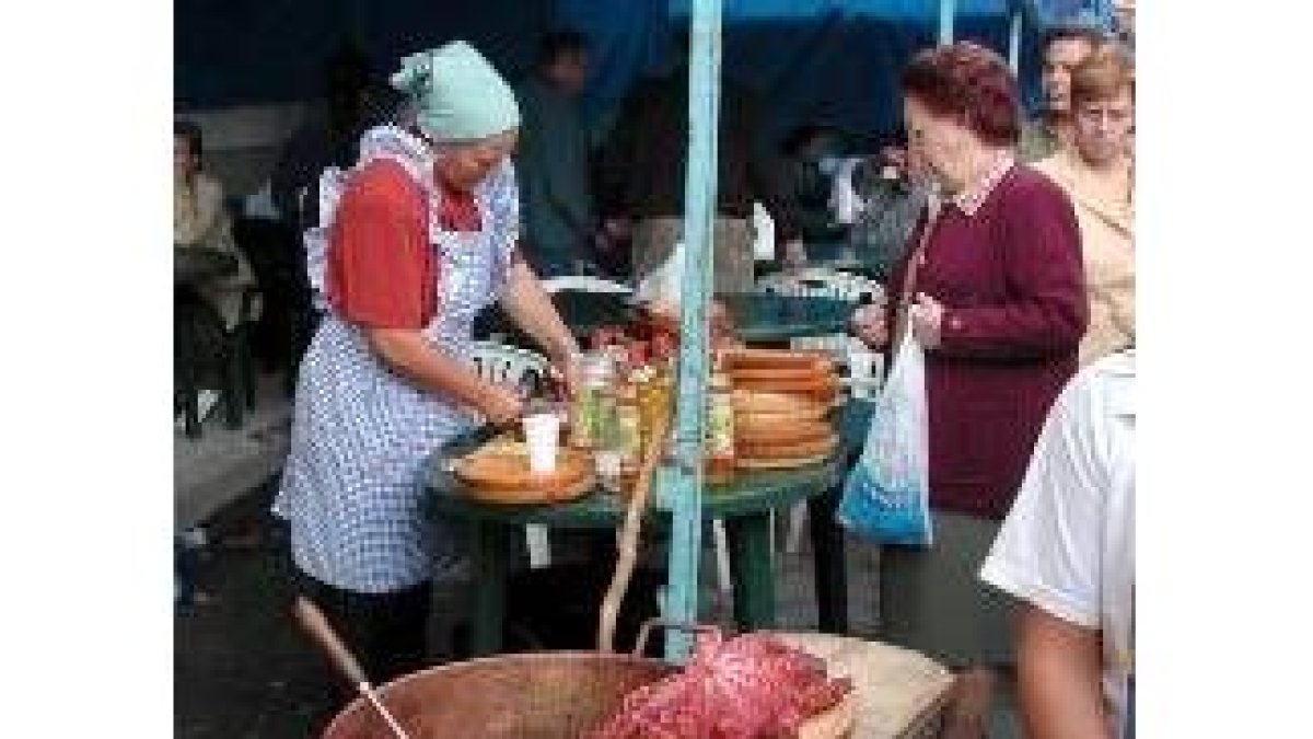 Una mujer sirve pulpo en uno de los puestos del mercadillo de Boñar, en una imagen de archivo