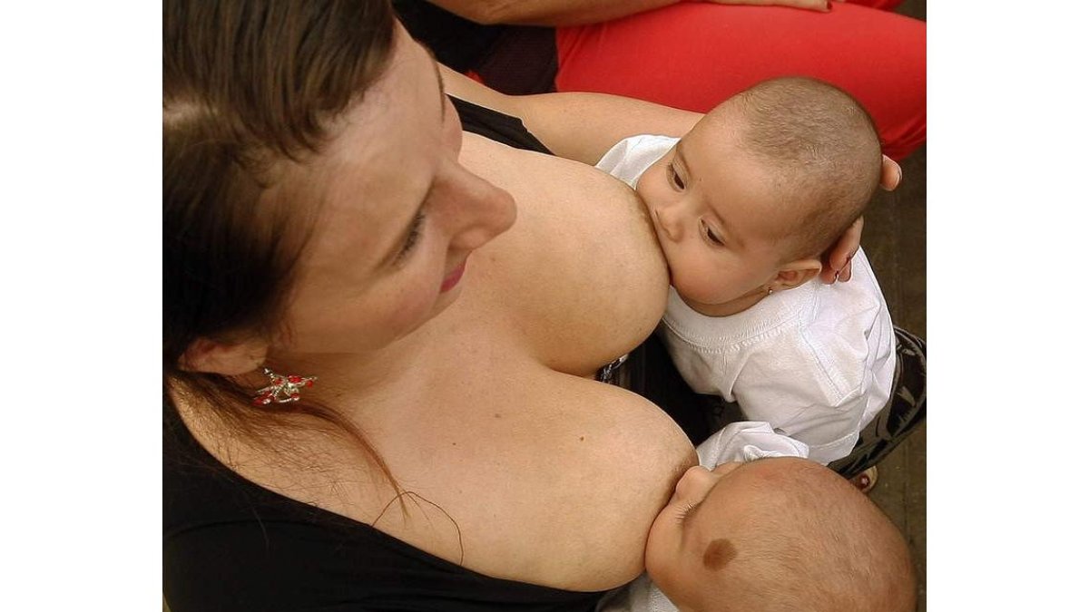 Una mujer amamanta a sus hijos en Medellín en una jornada de lactancia. LUIS EDUARDO NORIEGA