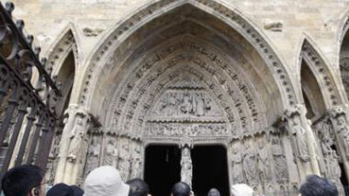 Varios turistas observan la fachada de la Catedral.