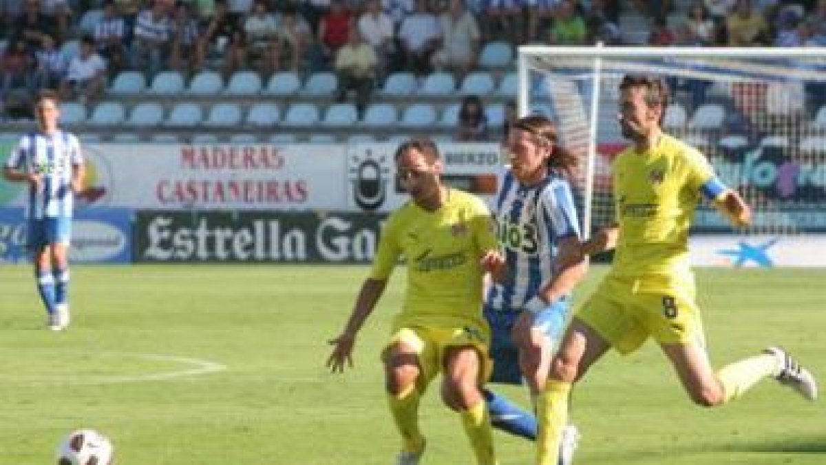 Miguel Ángel pelea un balón entre los jugadores del Villarreal B, Natxo Insa y Marcos Gullón.