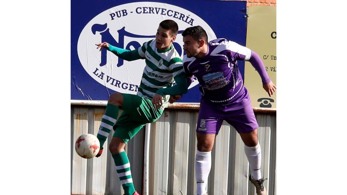 El virginiano Fraguas se lleva el balón ante el central Varo. MARCIANO