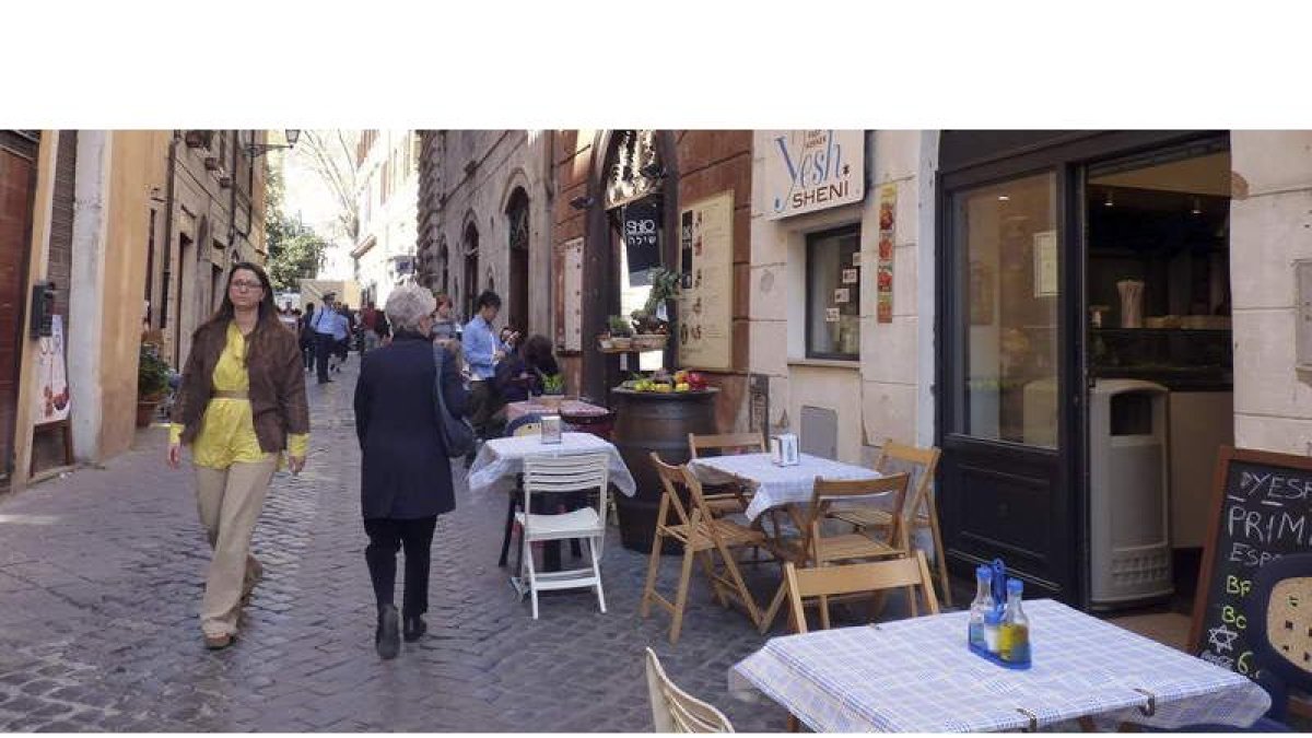Varios viandantes pasean por una calle del gueto de Roma, que celebra estos días la Pascua judía.