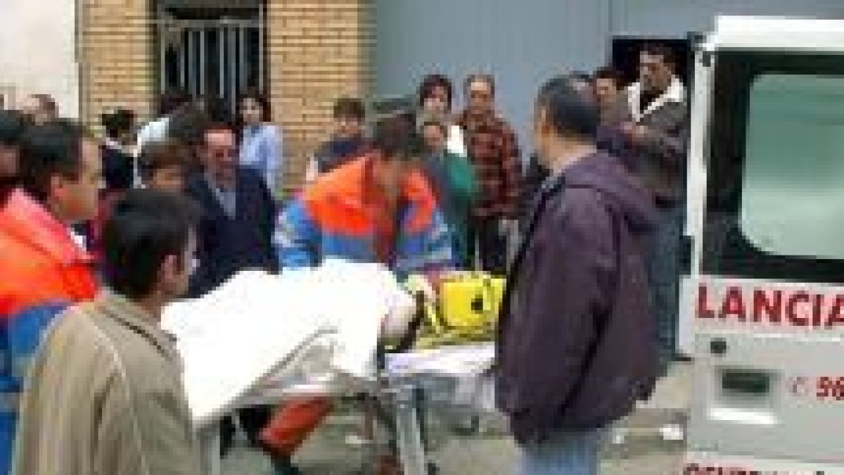 Momento en que el personal sanitario evacúa a una de las ocho personas heridas en el accidente