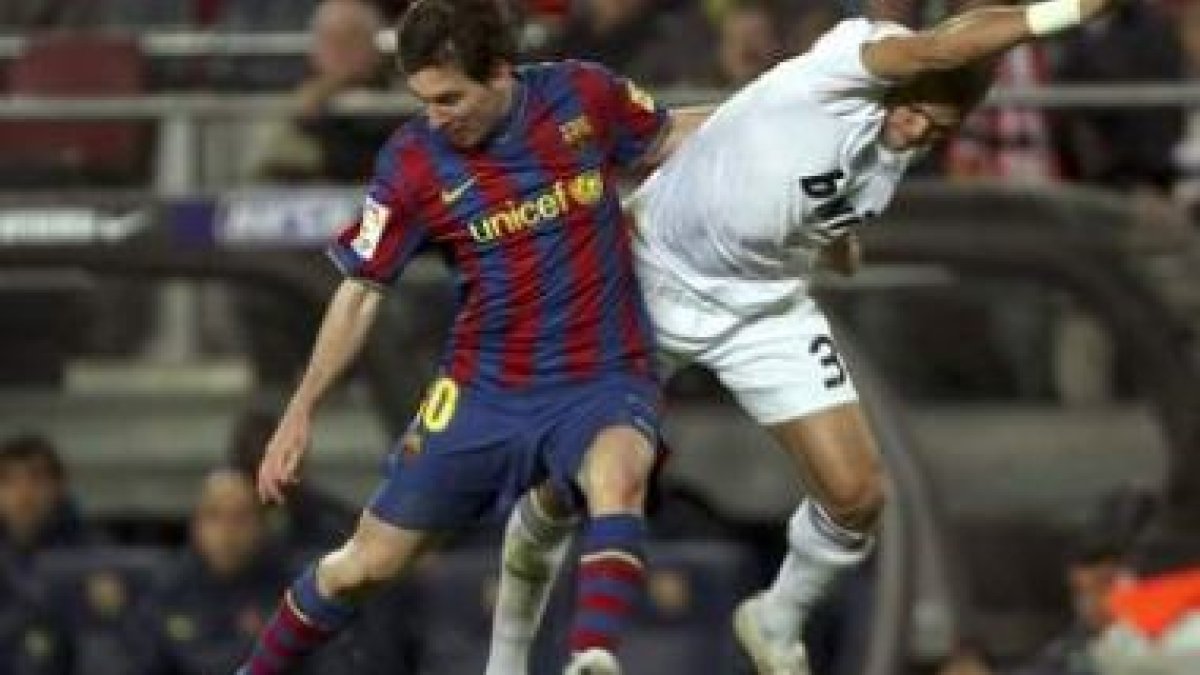 Lionel Messi, a la izquierda, pelea un balón con el defensa portugués del Real Madrid Pepe durante e