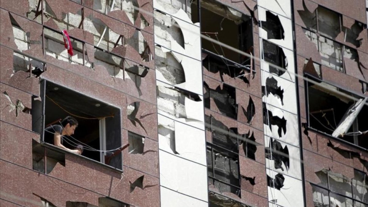 Edificio dañado por la explosión de un coche bomba en un barrio al sur de Damasco, Síria.