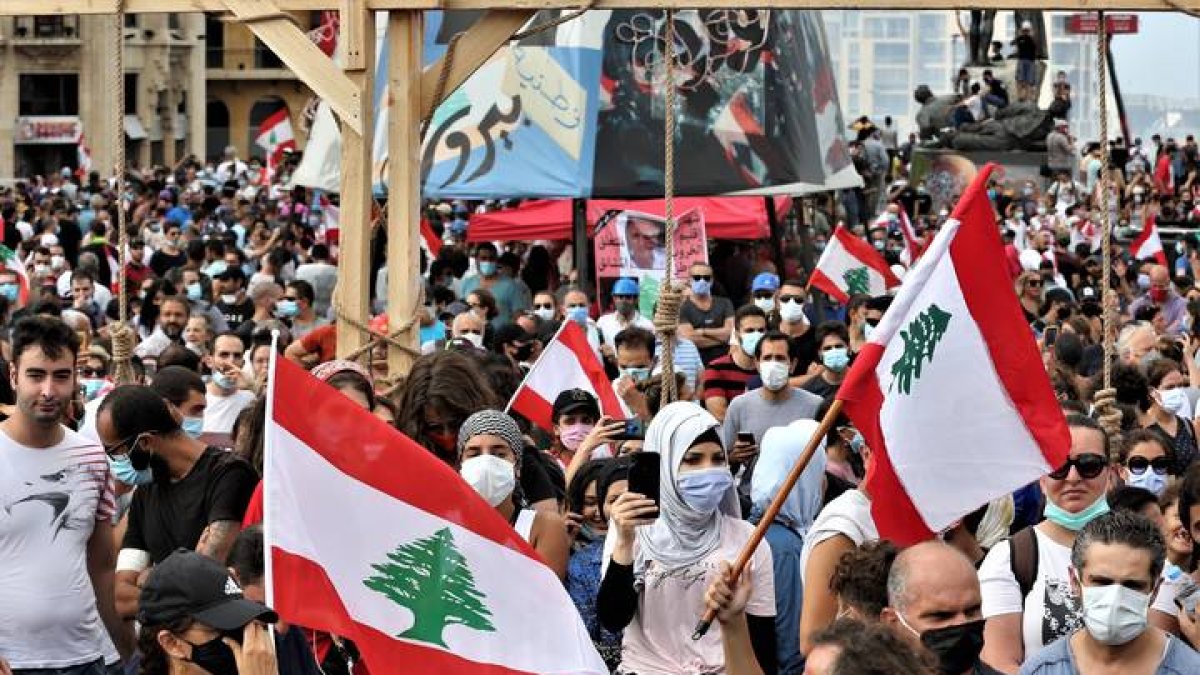 Manifestantes ondean banderas del Líbano en una manifestación de protestas tras la explosión del puerto de Beirut. NABIL MOUNZER