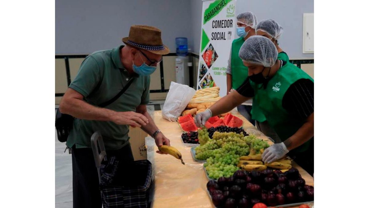 Una persona recibe alimentos en un comedor social en Madrid. FERNANDO ALVARADO