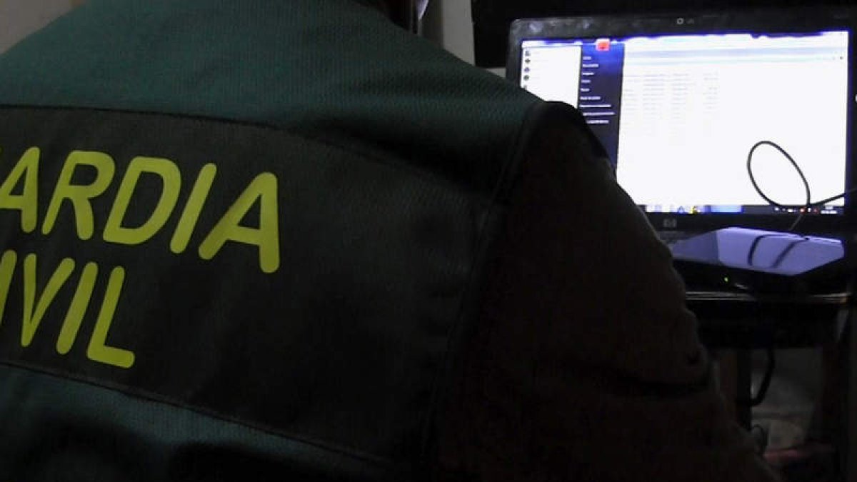 Un guardia civil investiga un ordenador de los criminales. EFE