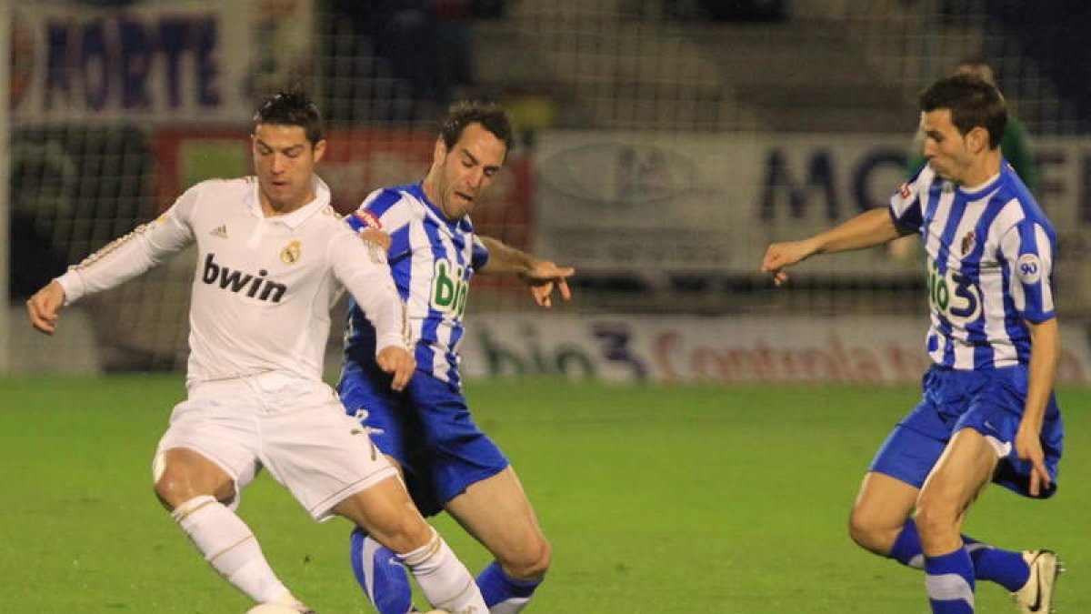 Cristiano Ronaldo trata de zafarse de dos jugadores de la Ponferradina en El Toralín. L. DE LA MATA