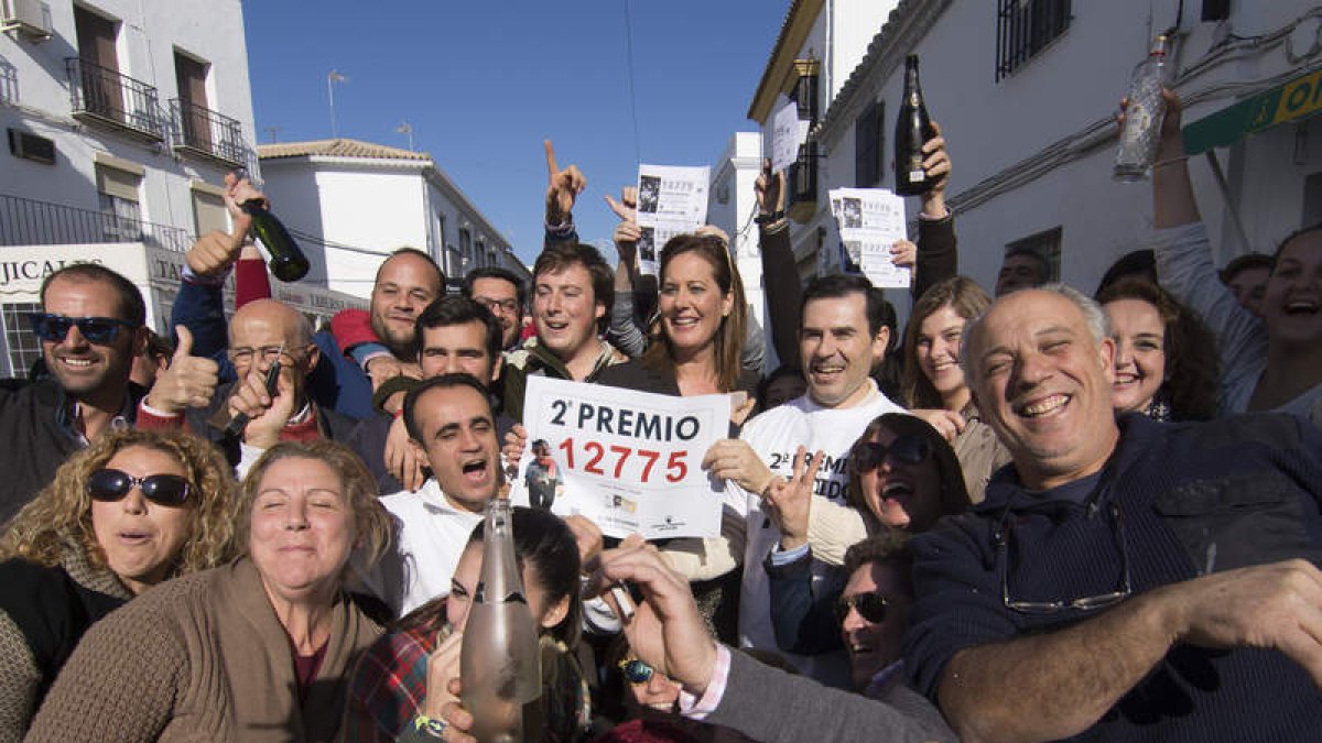 Rodeada de vecinos la alcaldesa de Osuna, Rosario Andújar, es una de las agraciadas.