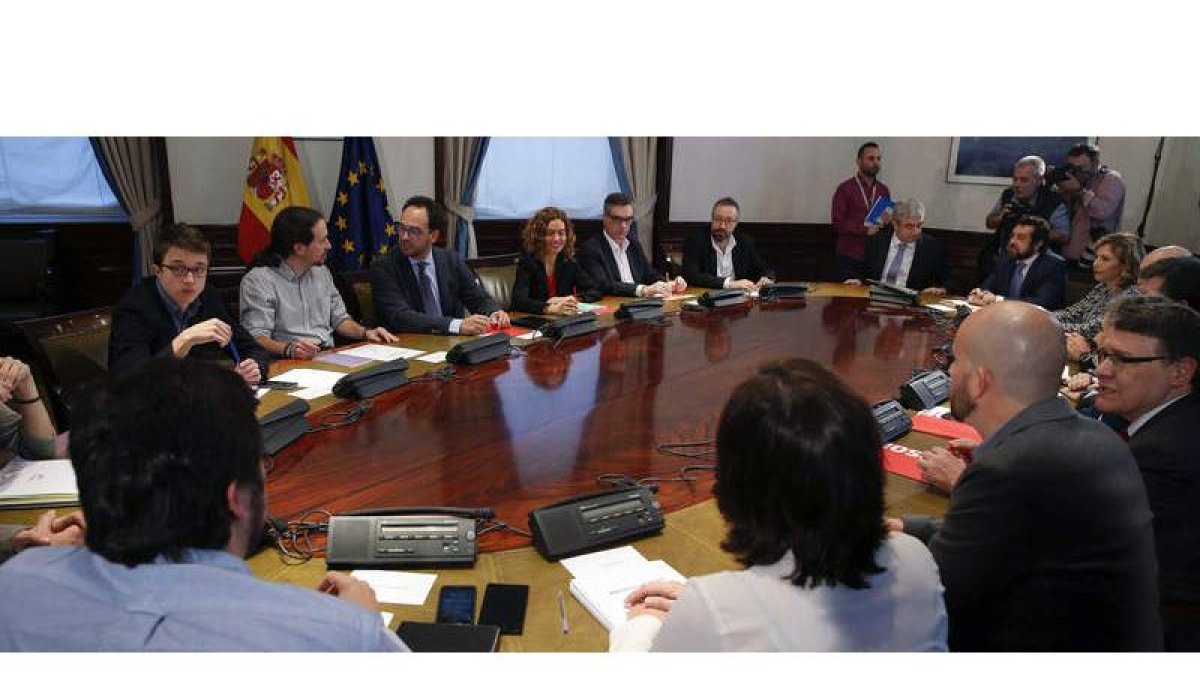 Los equipos negociadores del PSOE, Podemos y Ciudadanos, momentos antes del inicio de la reunión que mantuvieron ayer en una sala del Congreso. PACO CAMPOS