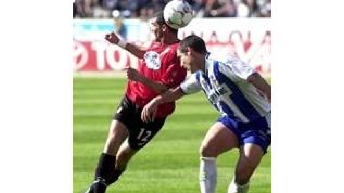 El alavesista Óscar Téllez disputa de cabeza un balón a Walter Pandiani
