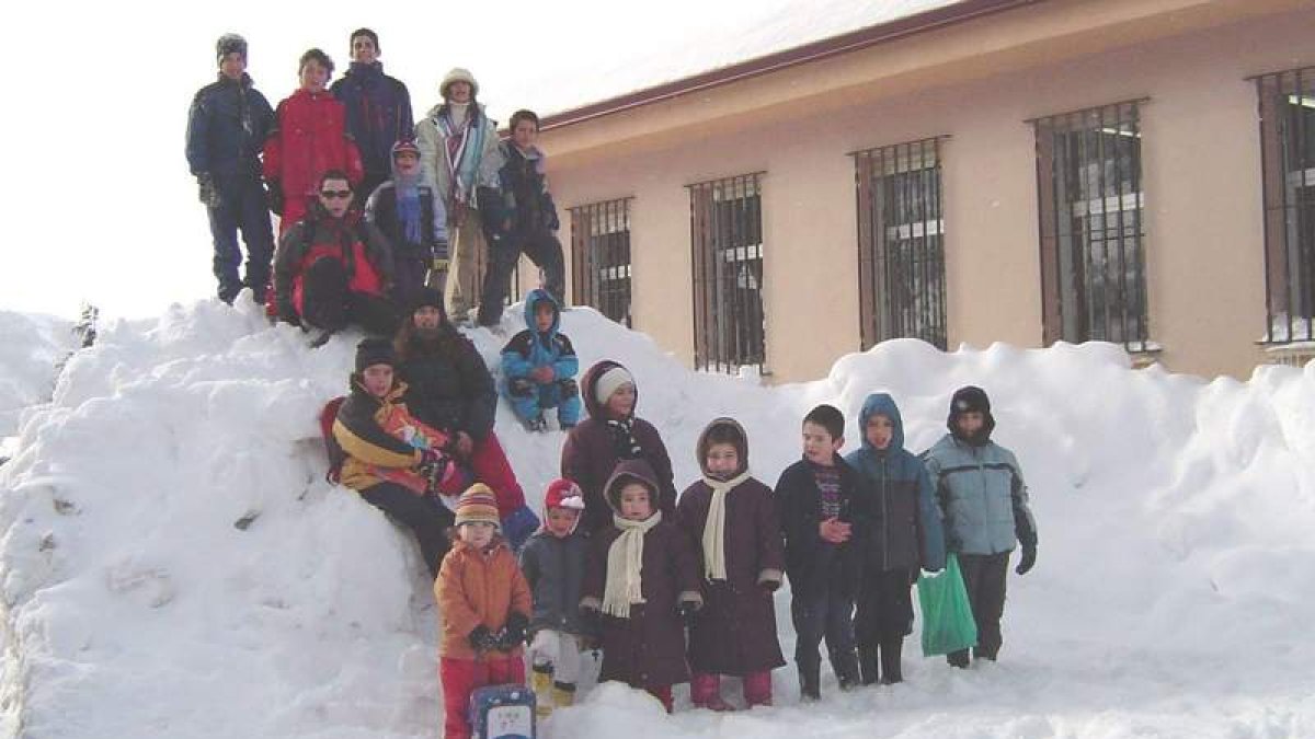 Escolares leoneses posan en la nieve ante su escuela.