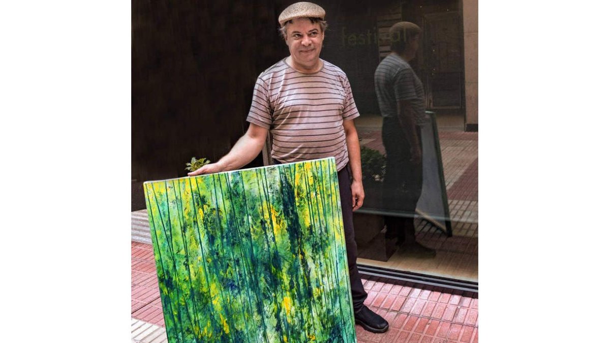 Juan Rafael con una de sus obras que se pueden ver en el bar Veloria. DL